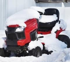 lawn mower covered with snow