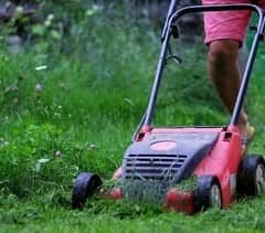 electric mower mowing wet grass