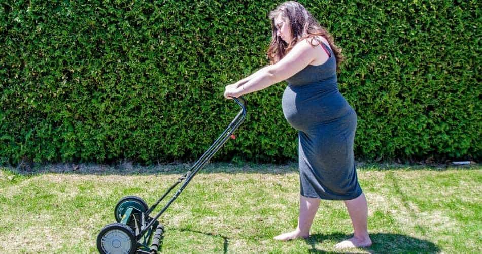 Pregnant Woman Mowing Lawn