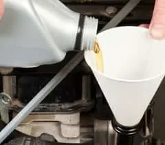 Using funnel to add engine oil
