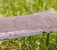 Dull mower blade with chips in the cutting edge