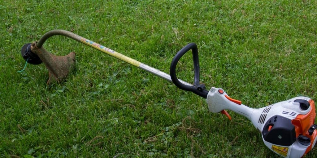String trimmer laying on the ground